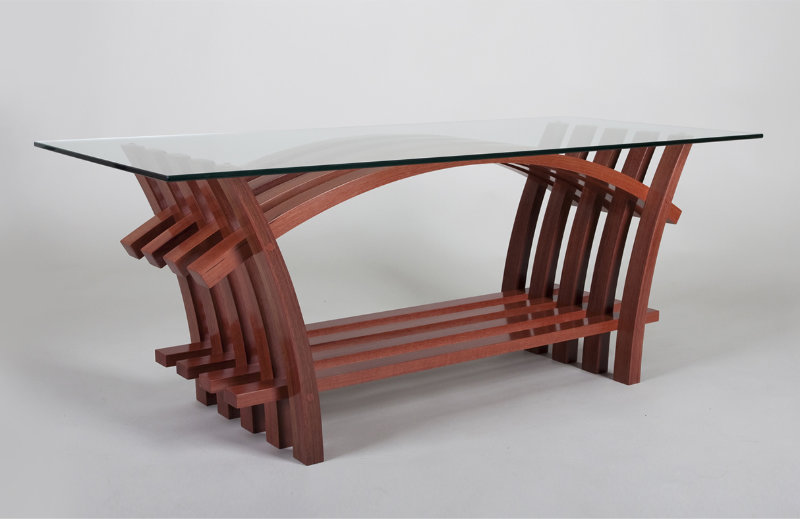 Modern wooden table with glass top and curved legs