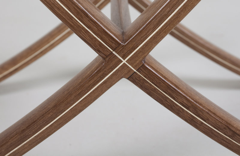 Close-up of a wooden table with a cross-bracing design
