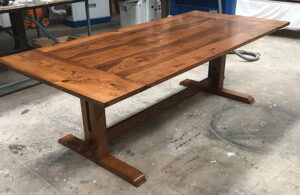 Wooden table with a live-edge top and trestle base